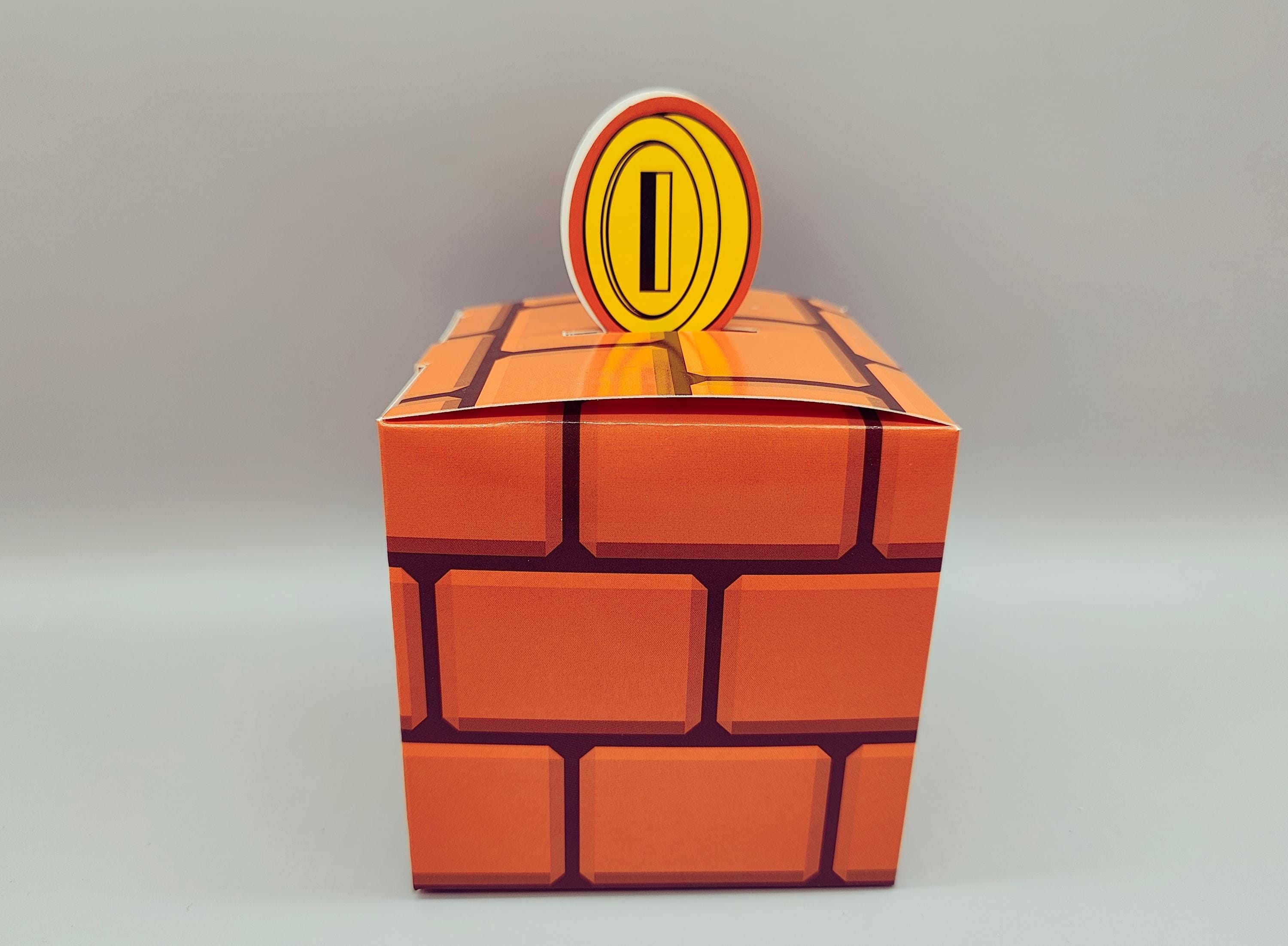 Set of 12 Super Mario Bros Favor Boxes - Brick, Question Mark, Sewer Pipe designs with Coins, Stars, Venus Flytrap. 4 of each box in a set.